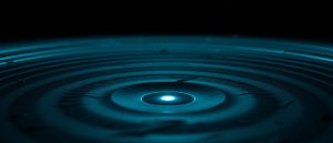 Sonar waves radiating from a single point over dark terrain — active scanning versus a cached search index